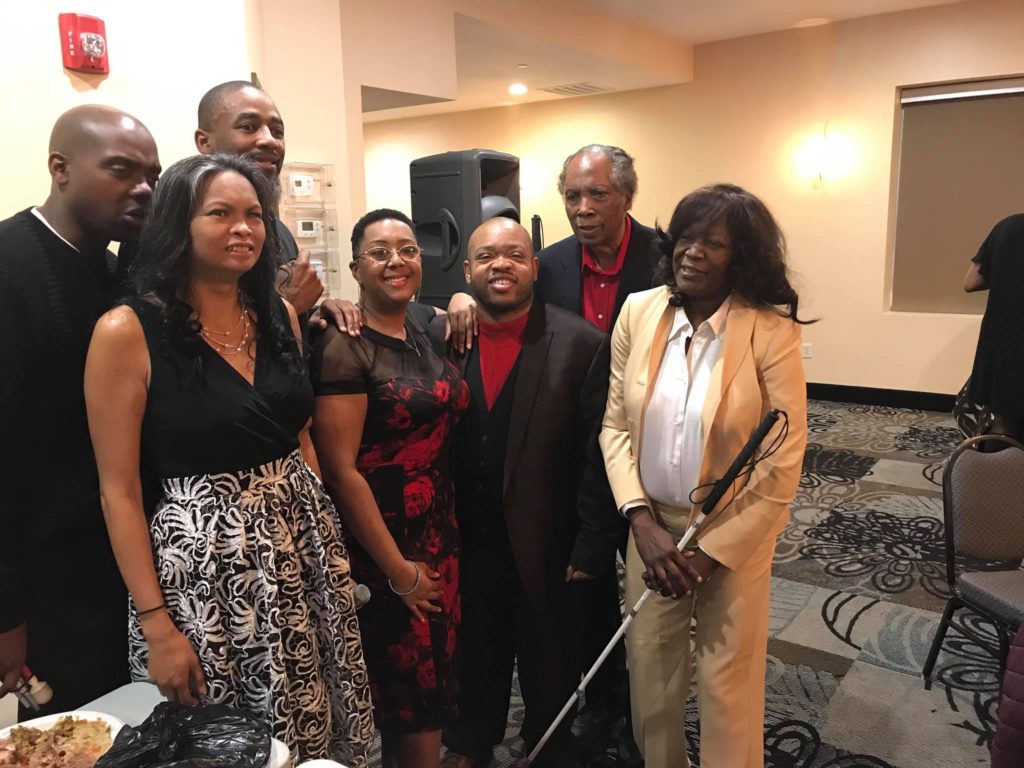 Seven people, standing, posing for camera, white cane christmas party 2018