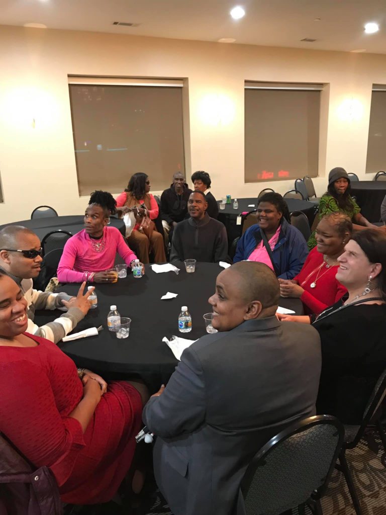 people sitting at round table at white cane christmas party 2018